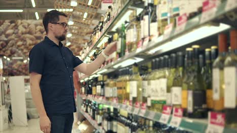 man shopping for wine in a grocery store