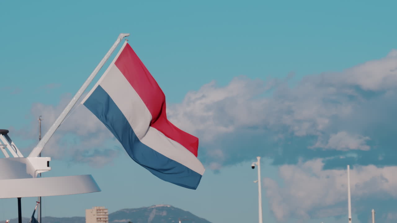 The flag of Netherlands waving on a boat docked in the Port Camille Rayon in Antibes, France