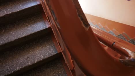 old building staircase with orange handrail