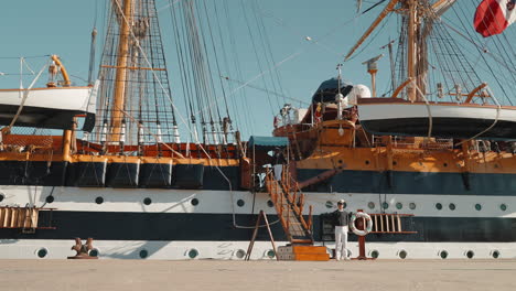 sailor on a historical sailing ship at the dock