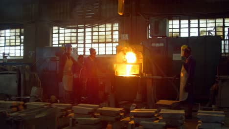 workers melting metal in foundry workshop 4k