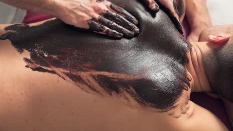 men's-hands-massage-their-backs-with-chocolate