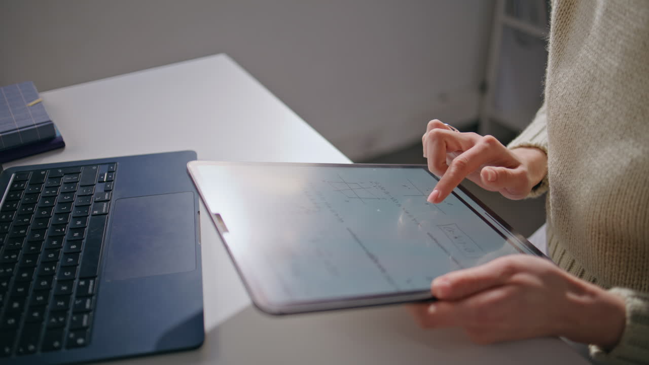 Educator hands using tablet at school workplace closeup. Teacher woman working