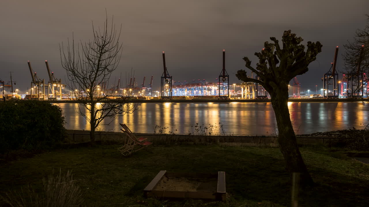 Hamburg harbor, container terminal at night colorful illuminated, time lapse