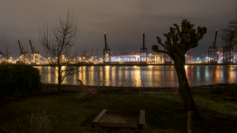 hamburg harbor, container terminal at night colorful illuminated, time lapse