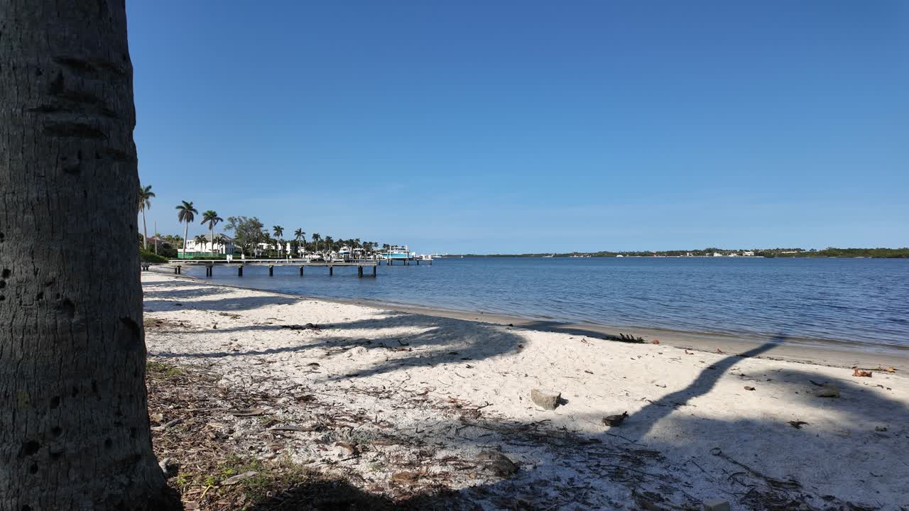 Static shot of Summa Beach Park in West Palm Beach Florida looking northeast over the Intracoastal Waterway showing the white sand and calm waters