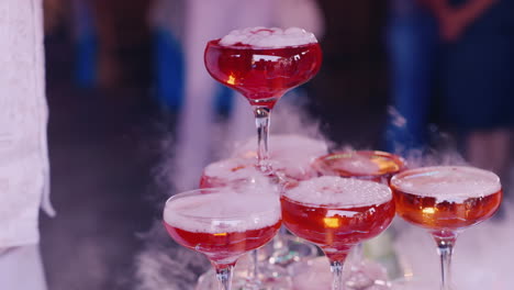 pour boiling pink drink in a baby party close-up