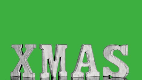 wooden christmas letters xmas in vintage style rotate on green screen