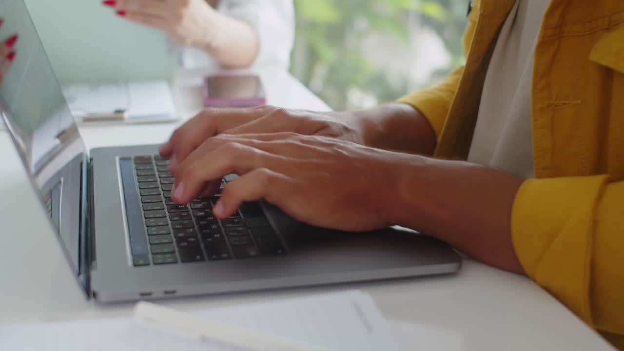 Unrecognizable Programmer Working on Laptop