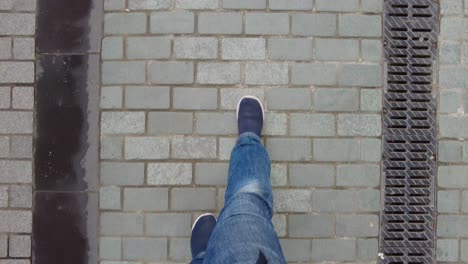 person walking on cobblestone pavement