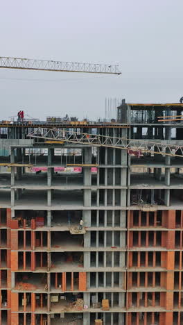 construction of a residential apartment complex. aerial view. vertical video