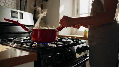woman cooking pasta in a kitchen
