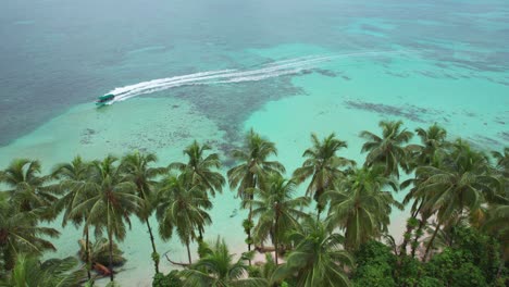 Aerial-view-of-boats-sailing-in-the-waters-of-Zapatilla-Cay-in-Bocas-del-Toro,-Panama_4K