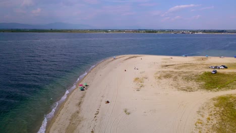 Drone-clip-moving-around-a-tropical-beach-with-golden-sand-in-the-area-of-Keramoti,-Kavala,-in-Northern-Greece-in-4k