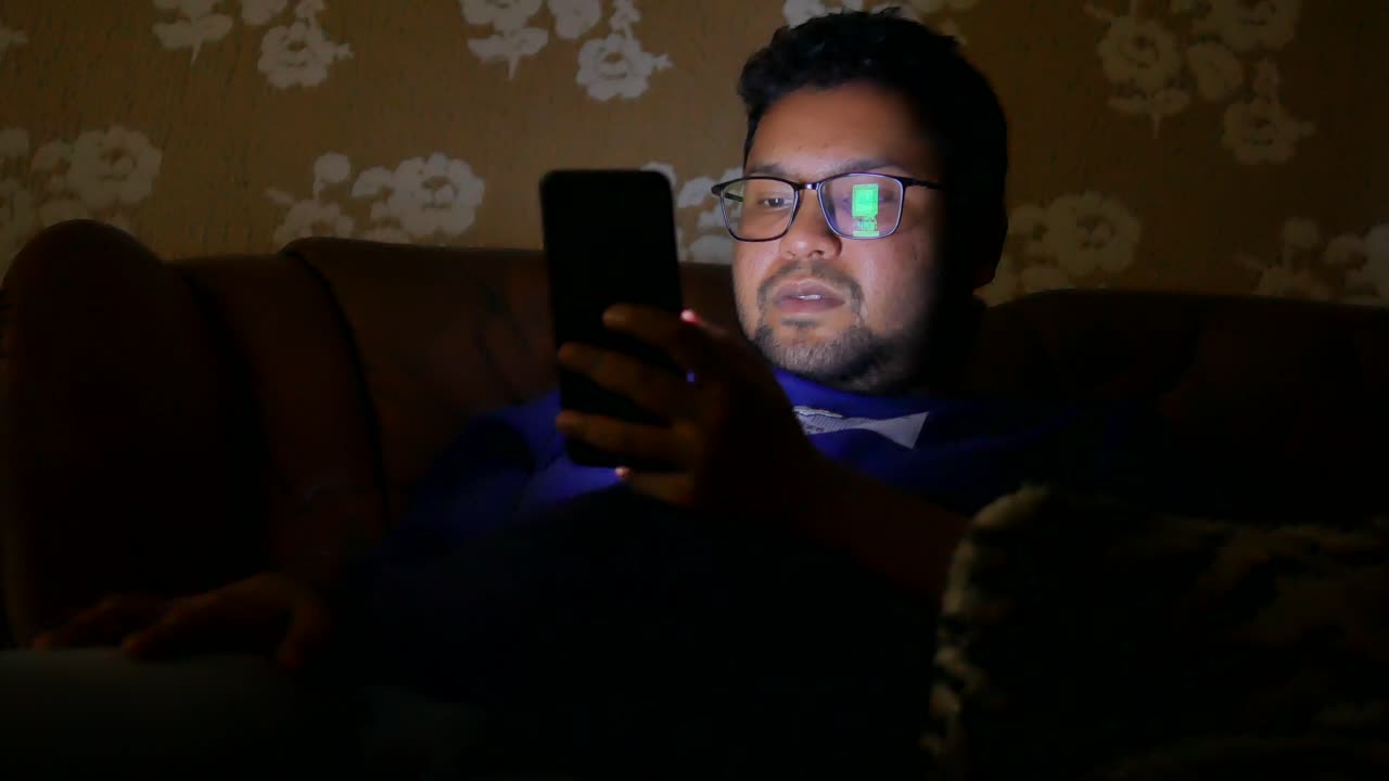 Man using a smartphone at night