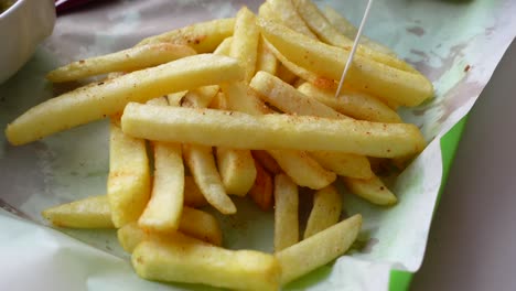 close up of a plate of golden french fries