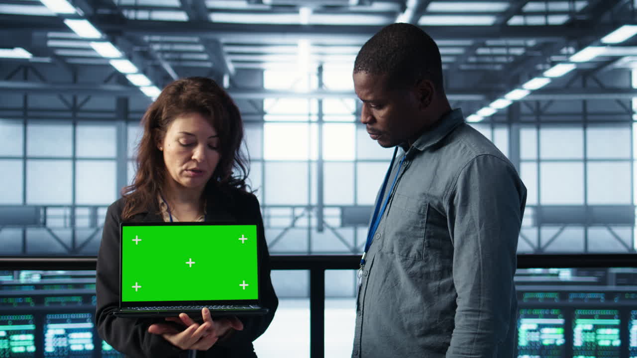 Server room coworkers using mockup notebook, adjusting power settings