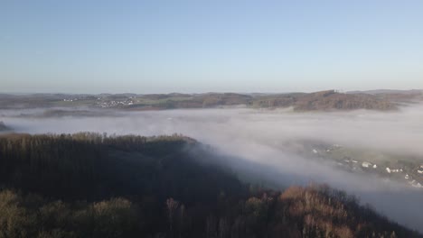 A-German-village-covered-completely-by-a-thick-layer-of-fog-at-sunrise