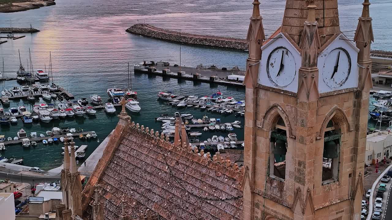 Pemandangan marina di Malta dekat gereja bersejarah saat matahari terbenam