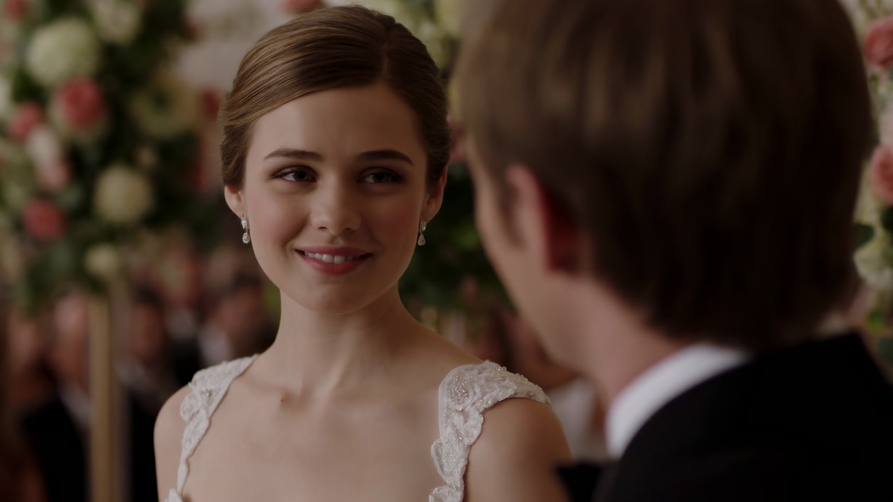 White Bride Smiling At Groom During Intimate Wedding Ceremony, Lace Gown, Floral Backdrop, Exchanging Vows,