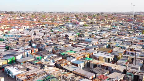 aerial over contrasting townships of south africa with poverty stricken slums streets and ghetto buildings