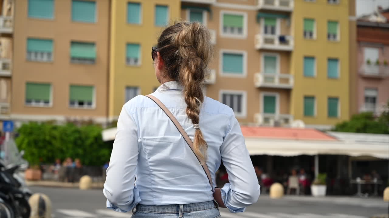 Woman walking on the street in San Remo, Italy