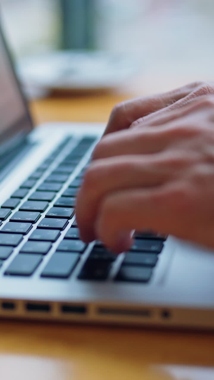 Image of man's hands typing on laptop. Selective focus. Business concept video. Vertical video