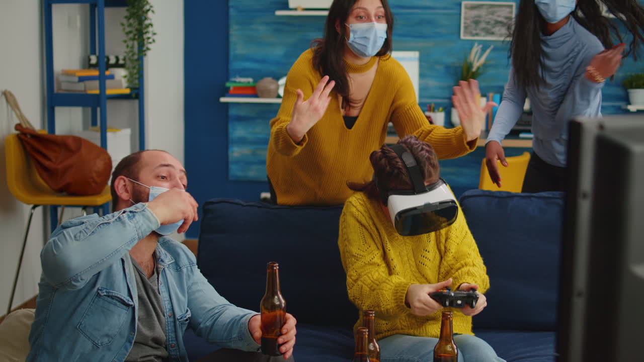 Mixed raced friends in living room having video game competion