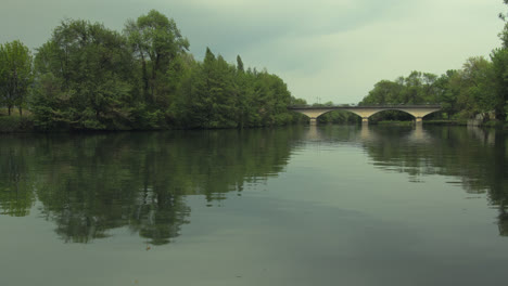 A-slight-overcast-hangs-over-a-calm-river-in-Cognac,-France