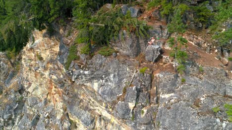 woman performing yoga on top of a mountain 4k