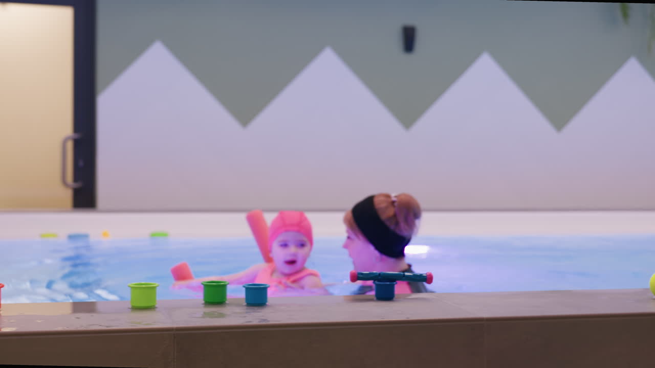 Blurry pillars obscure view of swimming pool, soft light reflecting on water surface, creating dreamy perspective with structural columns, blocking poolside environment and aquatic background details