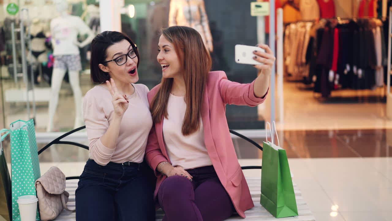 Two women taking a selfie in a shopping mall