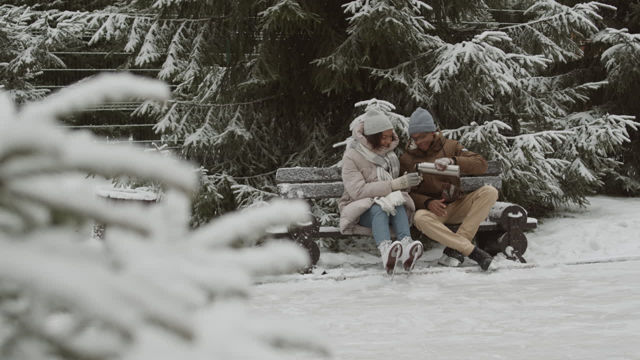 이 눈 인 겨울 날 에 뜨거운 음료 를 즐기고 있다