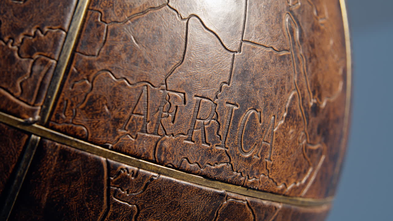 Mainland marked vintage globe macro view. Old brown surface illustrated Africa