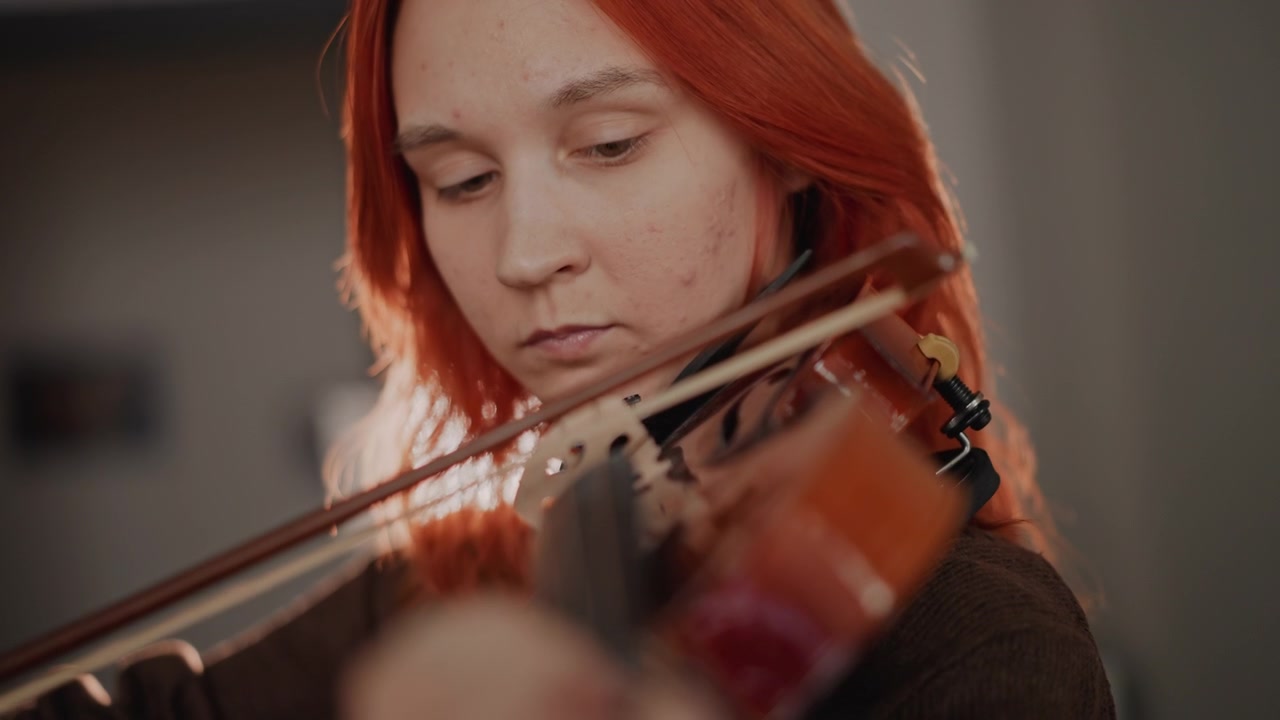Caucasian violin performer recording intimate session, soft warm light capturing vibrato and phrasing, closeup on hands and bow, emotional tone and focused expression, studio acoustics and solo