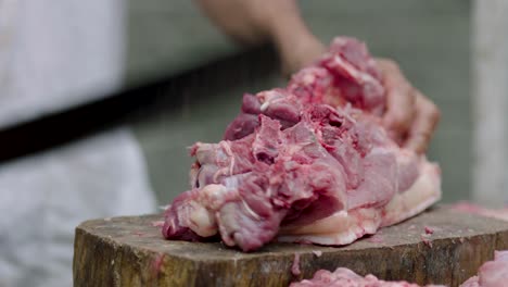 butcher cutting a piece of meat