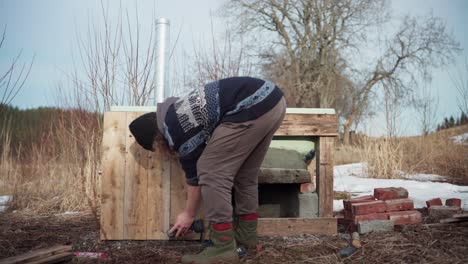 Male-Worker-Building-Hot-Tub-Outdoors---Wide-Shot