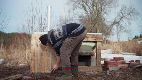 male worker building hot tub outdoors - wide shot