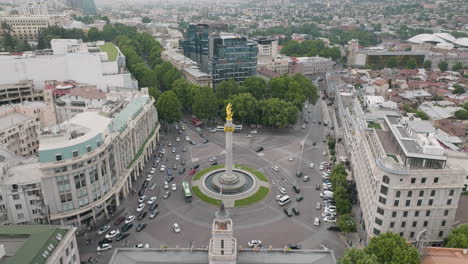 drone shot of a traffic around saint george monument on the liberty square