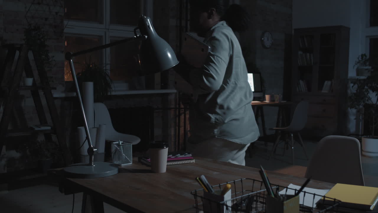 Woman Finishing Work and Leaving Office Late at Night