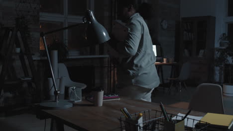 woman finishing work and leaving office late at night