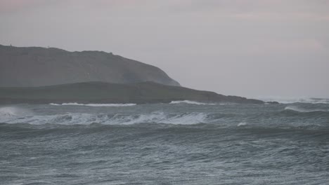 Handheld-blue-hour-footage-of-waves-and-tidal-swell-at-the-shore-of-Ireland