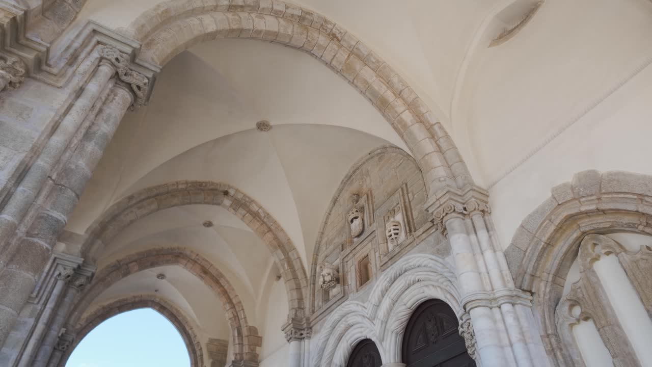 Architectural details of the gothic Sao Francisco Church entrance in Evora, Portugal, bathed in sunlight