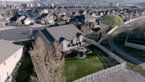 ascending aerial view of a home with backyard outdoor living space