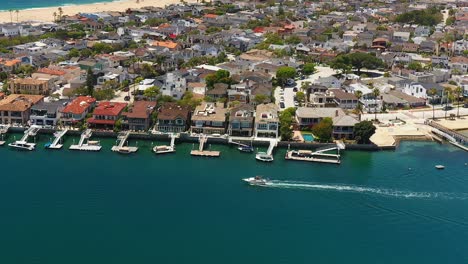 aerial view of a boat in the channel off of balboa island, in newport beach, california