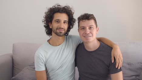 happy handsome gay couple posing at home