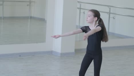 young ballet girl at studio lesson. training performance. stretching exercise pose. ballerina practice balance technique. classical elegance fitness.