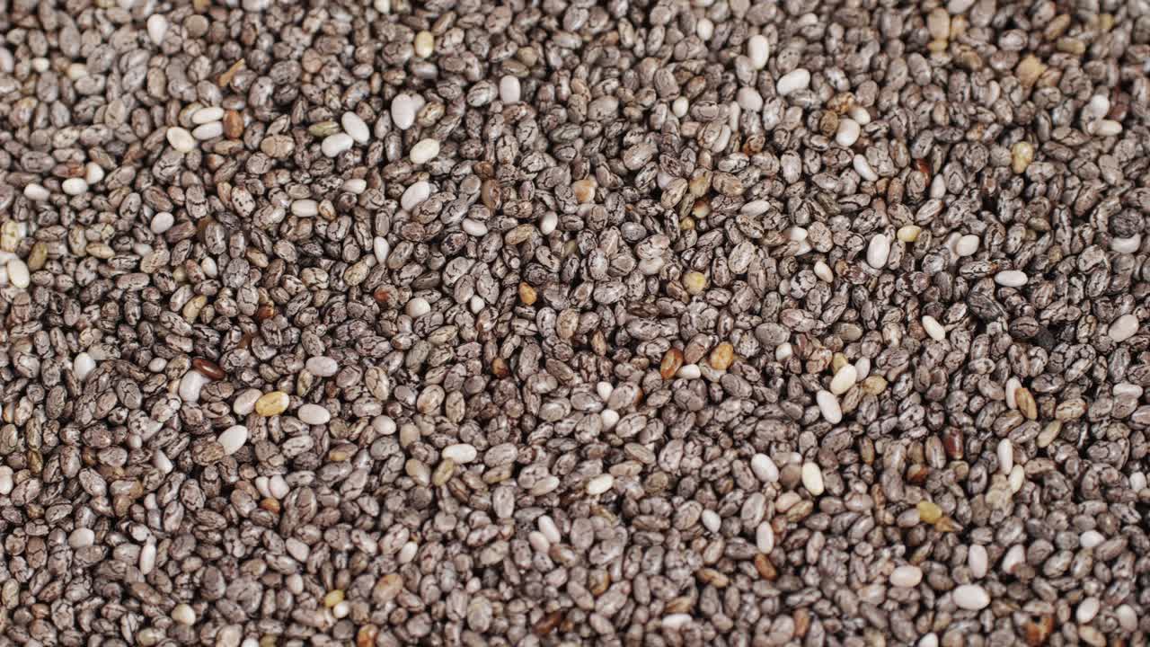Chia seeds close-up macro. Dry healthy ingredient. Healthy superfood rich in Omega 3 fatty acids. Salvia hispanica. High quality 4k footage