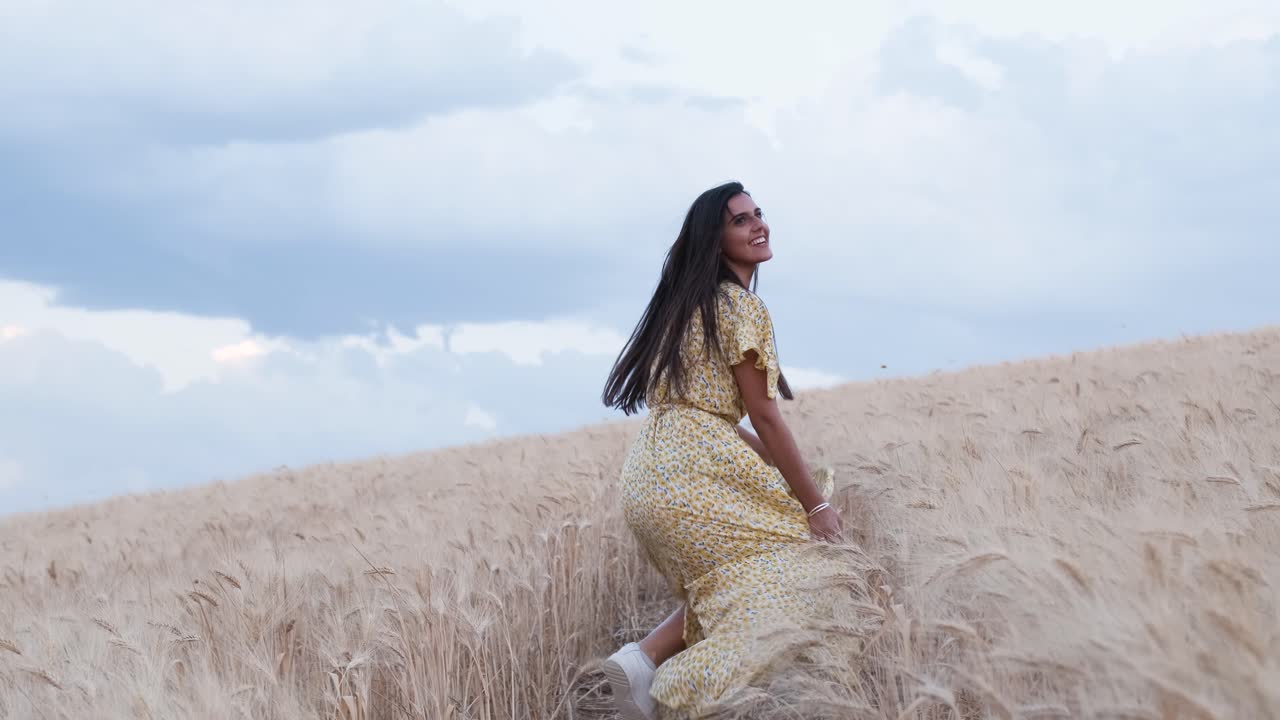carefree woman enjoying nature while running through a wheat field. Slow motion 4k footage