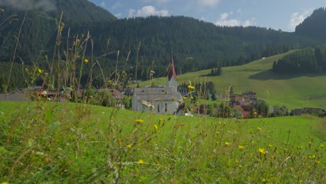 church in a peaceful mountain village surrounded by lush green meadows and wildflowers